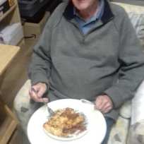 Dad enjoying Tim's lasagne in October 2021